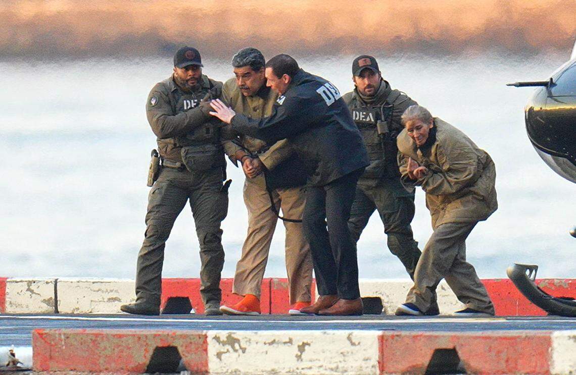 Nicolas Maduro and his wife, Cilia Flores, are seen in handcuffs after landing at a Manhattan helipad, escorted by heavily armed federal agents as they make their way into an armored car en route to a Federal courthouse in Manhattan on Jan. 5, 2026, in New York City. 