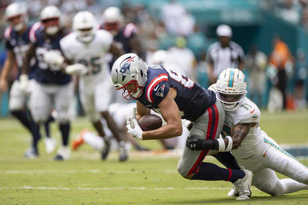Miami Dolphins linebacker Tyrel Dodson (11) tackles New England Patriots tight end Hunter Henry (85) in the first half of their NFL game at Hard Rock Stadium on Sunday, Sept. 14, 2025, in Miami Gardens, Fla.