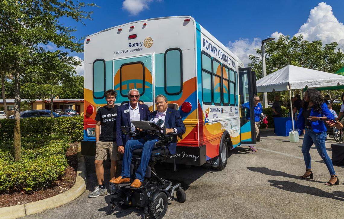 From left- Artist Sam Danzig, Rotary presidents Rick Riccardi (past) and Jeffrey Michael Shaffner (present), posed next to the first free bus for homeless people that drives a local route to bring people to resources in the area, sponsored by of the Rotary Club of Fort Lauderdale, on Friday, August 01, 2025.
