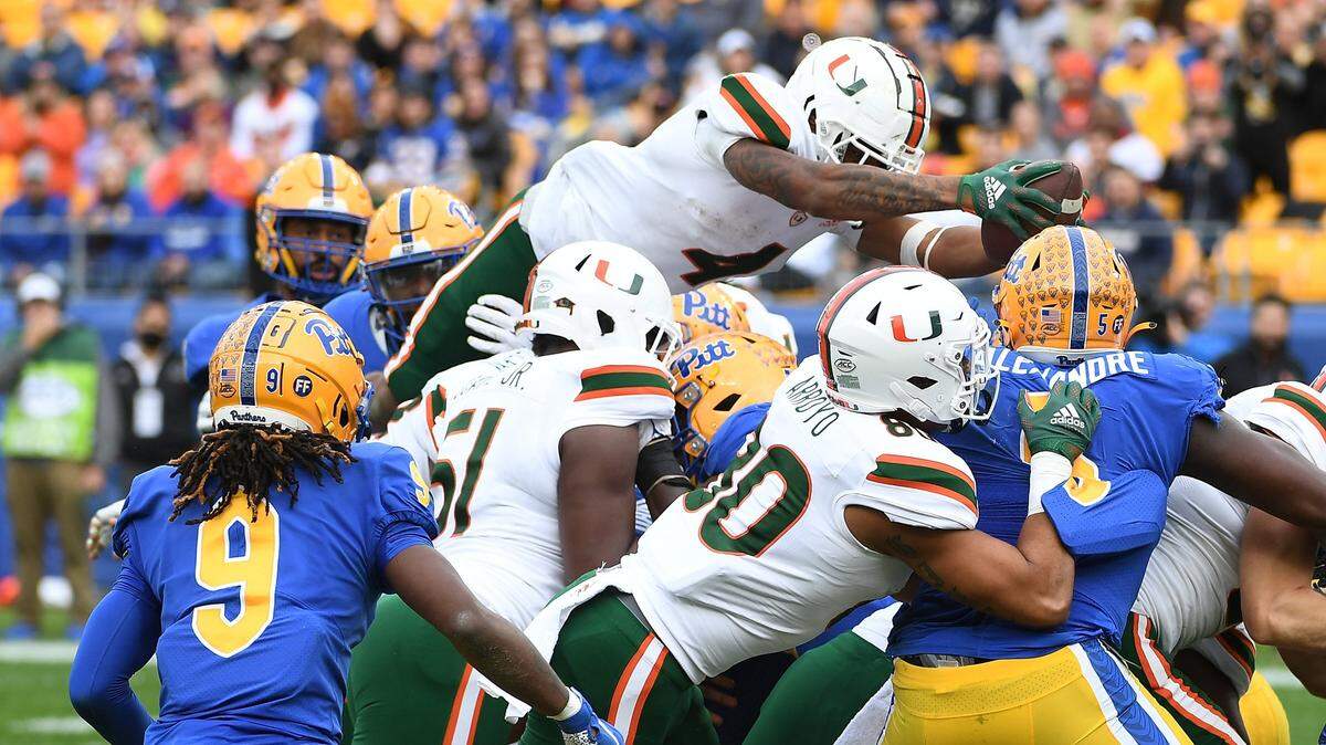 PITTSBURGH, PA - OCTOBER 30: Jaylan Knighton #4 of the Miami Hurricanes jumps into the end zone for a 1-yard touchdown run in the second quarter during the game against the Pittsburgh Panthers at Heinz Field on October 30, 2021 in Pittsburgh, Pennsylvania. (Photo by Justin Berl/Getty Images)