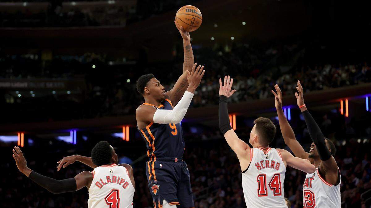 New York Knicks guard RJ Barrett (9) shoots against Miami Heat guards Victor Oladipo (4) and Tyler Herro (14) and center Bam Adebayo (13) during the fourth quarter at Madison Square Garden.