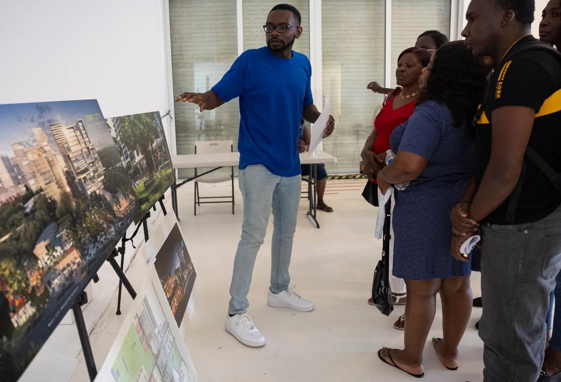 Sammy Lamy, the director of Jobs For Us, talks with a group of attendees during a community resource fair at the Magic City Innovation District on Friday, May 31, 2024, in Miami, Fla. The fair aimed at helping recently arrived Haitians and other immigrants connect with health care providers and prospective employers.