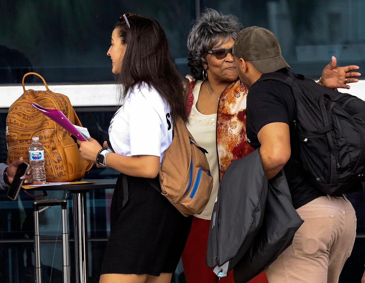 Cruisers Sierra Foster, 22, Anna Smith, 83, and Shaheem Stupart, 23, right, fill out travel notice forms before boarding the Carnival Sensation at PortMiami on Monday, March 9, 2020. The U.S. State Department issued a travel advisory Sunday saying: ‘U.S. citizens, particularly travelers with underlying health conditions, should not travel by cruise ship.’