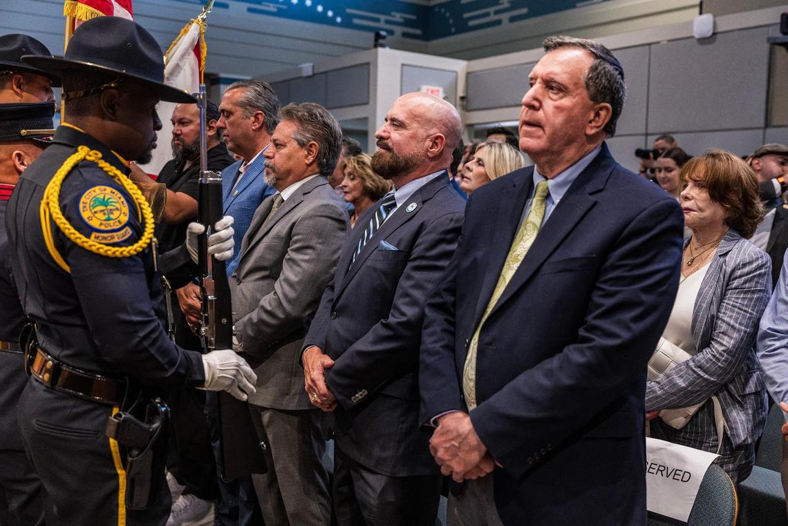 Miami City Commissioners Miguel Angel Gabela (center left), Damian Pardo (center) and Joe Carollo (far right) stand up for the presentation of the colors during the swearing-in ceremony for newly elected District 4 Commissioner Ralph Rosado at Miami City Hall on Tuesday, June 10, 2025.