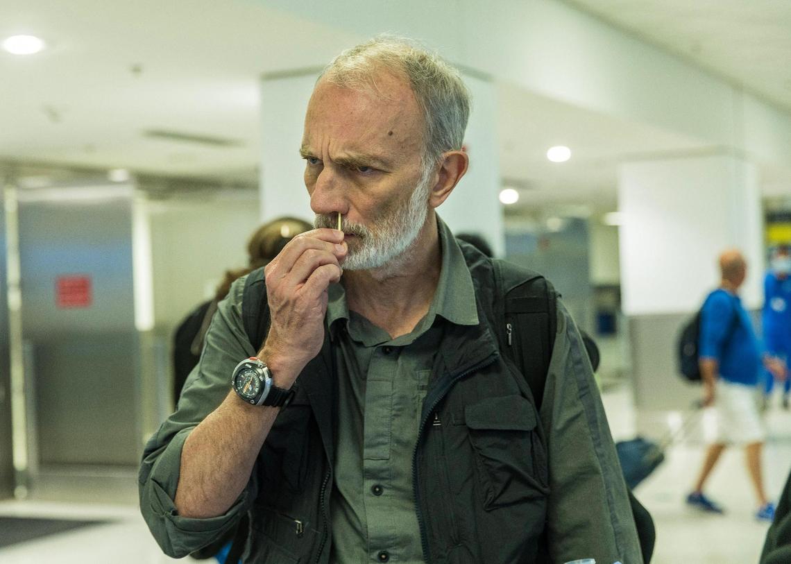 Traveler Bertrand Guenot arriving from the Bahamas on his way to Paris swabs his nose for a voluntary test as some travelers flying into Miami from other countries are being asked to do a nose swab to test for COVID variants and other contagious viruses as part of a nationwide effort to track new and emerging infectious diseases, on Thursday, March 14, 2024.