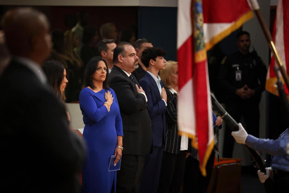 Maria Bosque-Blanco, the new Miami-Dade School Board member that Gov. DeSantis appointed on Tuesday, stands for the Pledge of Allegiance before her swearing-in ceremony at the Miami-Dade School Board headquarters on Wednesday, Jan. 18, 2023.