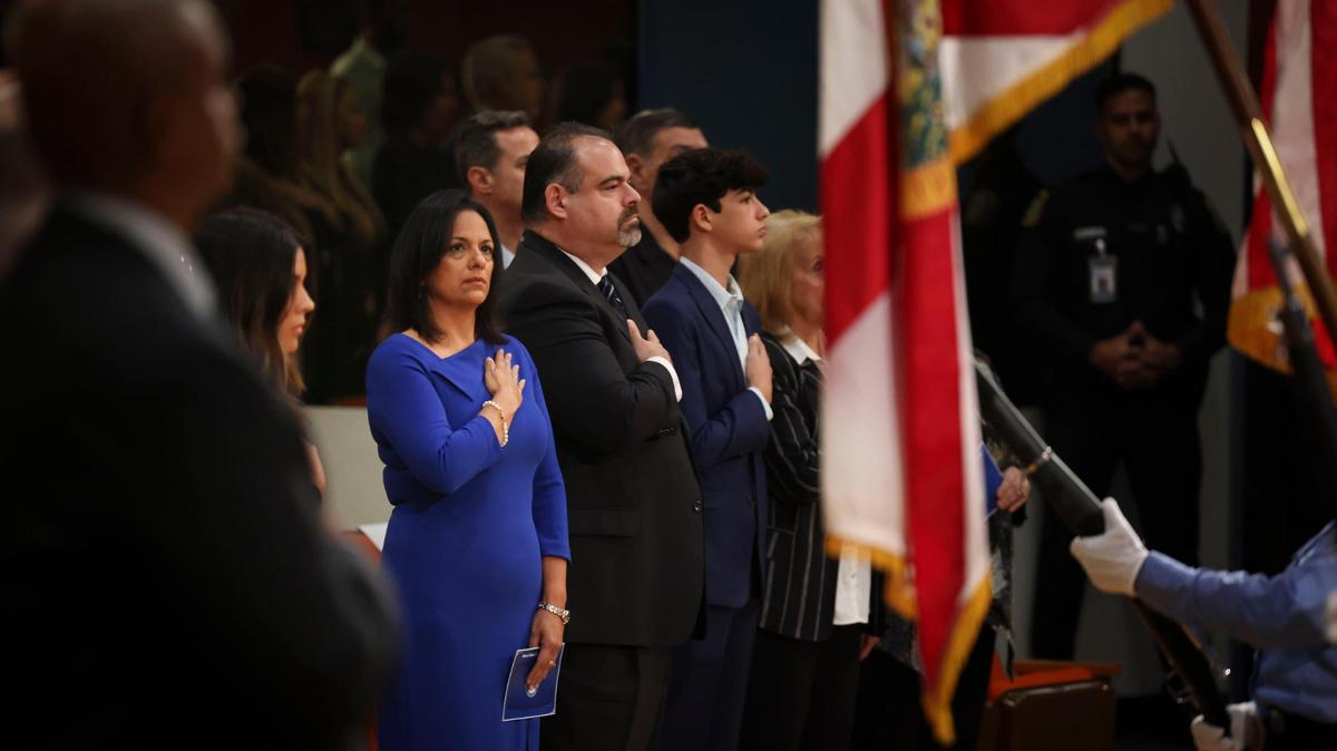 Maria Bosque-Blanco, newly appointed Miami-Dade School Board member, stands for the Pledge of Allegiance before her swearing-in ceremony on Wednesday, Jan. 18, 2023, in downtown Miami. Gov. DeSantis appointed her to the board on Jan. 17 to replace Lubby Navarro, who resigned after a new state law prevented lobbyists from serving as elected officials. Navarro is a lobbyist.