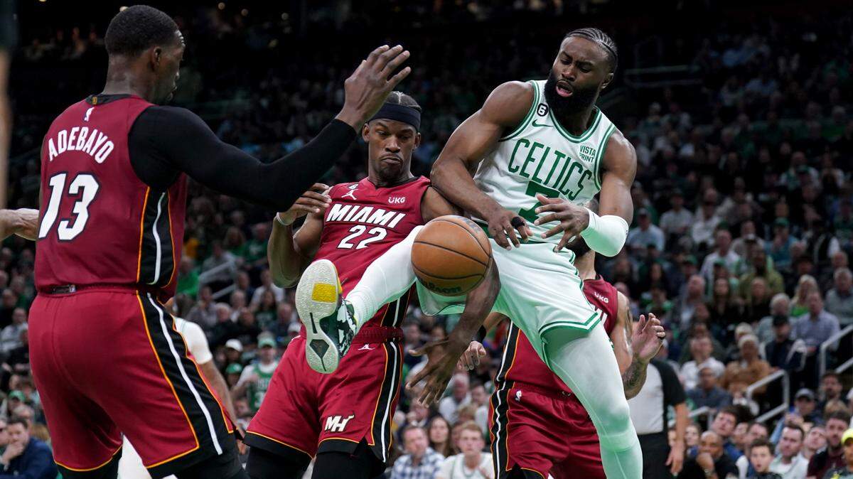 Boston Celtics guard Jaylen Brown (7) fights for a loose ball with Miami Heat forward Jimmy Butler (22) and center Bam Adebayo (13) during the first half of game two of the Eastern Conference Finals for the 2023 NBA playoffs at TD Garden.