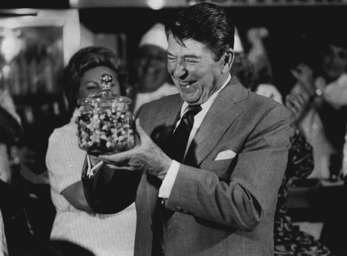 President Reagan holds a jar of jelly beans given to him after he had lunch in Little Havana in 1983.