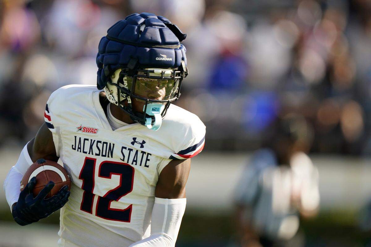 White cornerback Travis Hunter (12) catches a pass in the first half of Jackson State’s Blue and White Spring football game, an NCAA college football contest, Sunday, April 24, 2022, in Jackson, Miss. (AP Photo/Rogelio V. Solis)