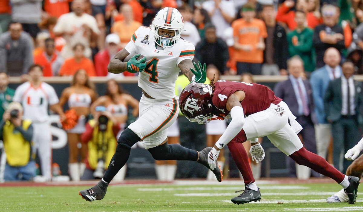 Miami Hurricanes running back Mark Fletcher Jr. (4) on a run as Texas A&M Aggies cornerback Will Lee III (4) defends in the first half of the first round of the 2025 College Football Playoff at Kyle Field at College Station, Texas, on Saturday, December 20, 2025.