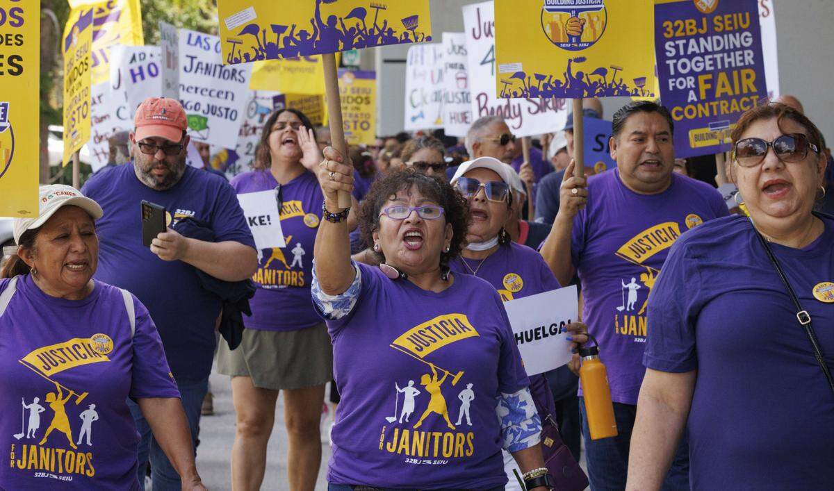 People march during a strike vote march held by janitors employed by UM's cleaning contractor, ABM, on Monday, Aug. 18, 2025, outside of the University of Miami in Coral Gables, Fla.