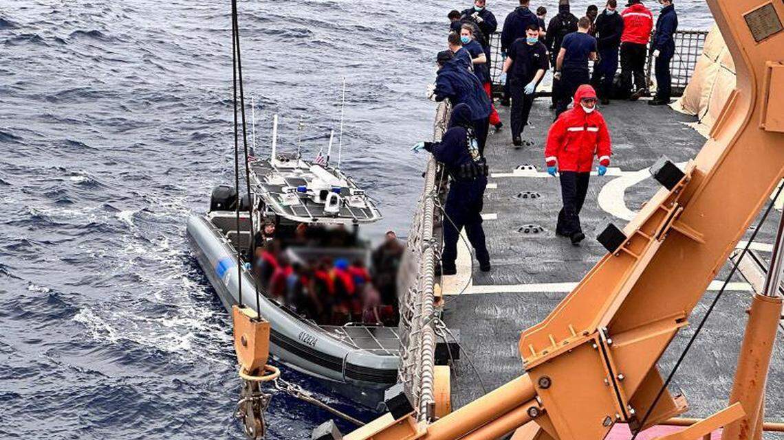 A U.S. Customs and Border Protection Air and Marine Operations boat transfers a group of Haitian migrants to a Coast Guard cutter Monday, Nov. 21, 2022, off the Florida Keys.