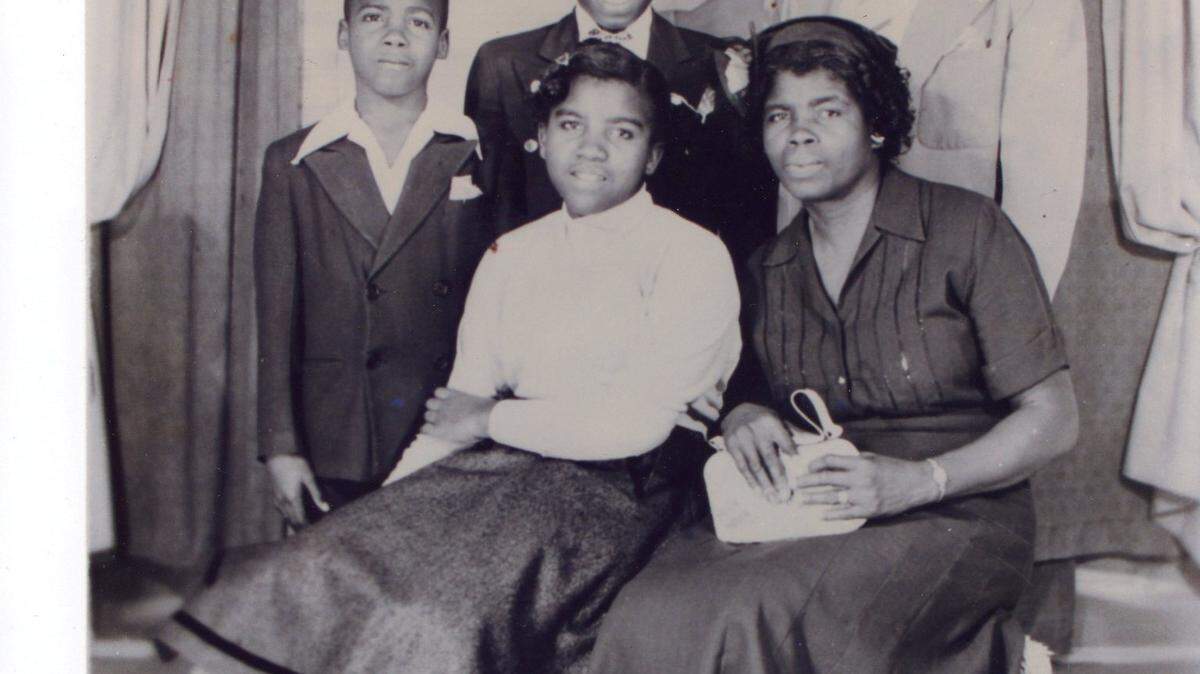 Seated, from left to right: Evalina Williams Bestman and her mother Florence Poitier Williams. Standing: Charles and David Williams, sons of Florence and David Williams, who is standing behind his sons.