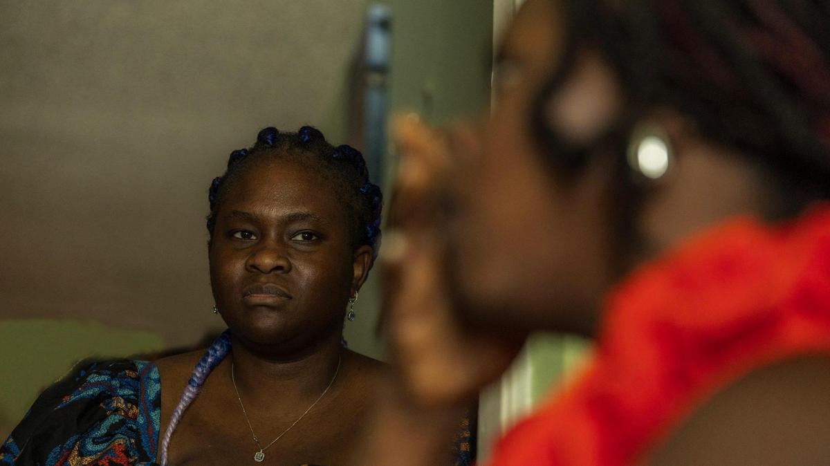 Rivly Breus, director of operations for the Erzule Paul Foundation, listens as Flo, a beneficiary of the Biden-era humanitarian program known as CHNV, talks about the Supreme Court decision Friday to let the Trump administration end the program for Cubans, Haitians, Nicaraguans and Venezuelans.