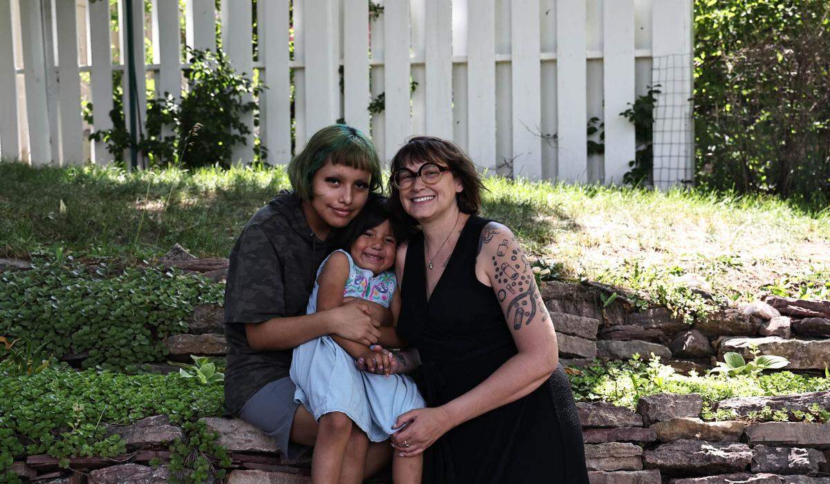 “My doctor saved my life, but my medical bills are stealing from my children’s lives,” says Jeni Rae Peters, pictured with her daughters, Braelyn Featherman (left) and Lisha Jane Featherman. (Dawnee LeBeau for KHN and NPR)