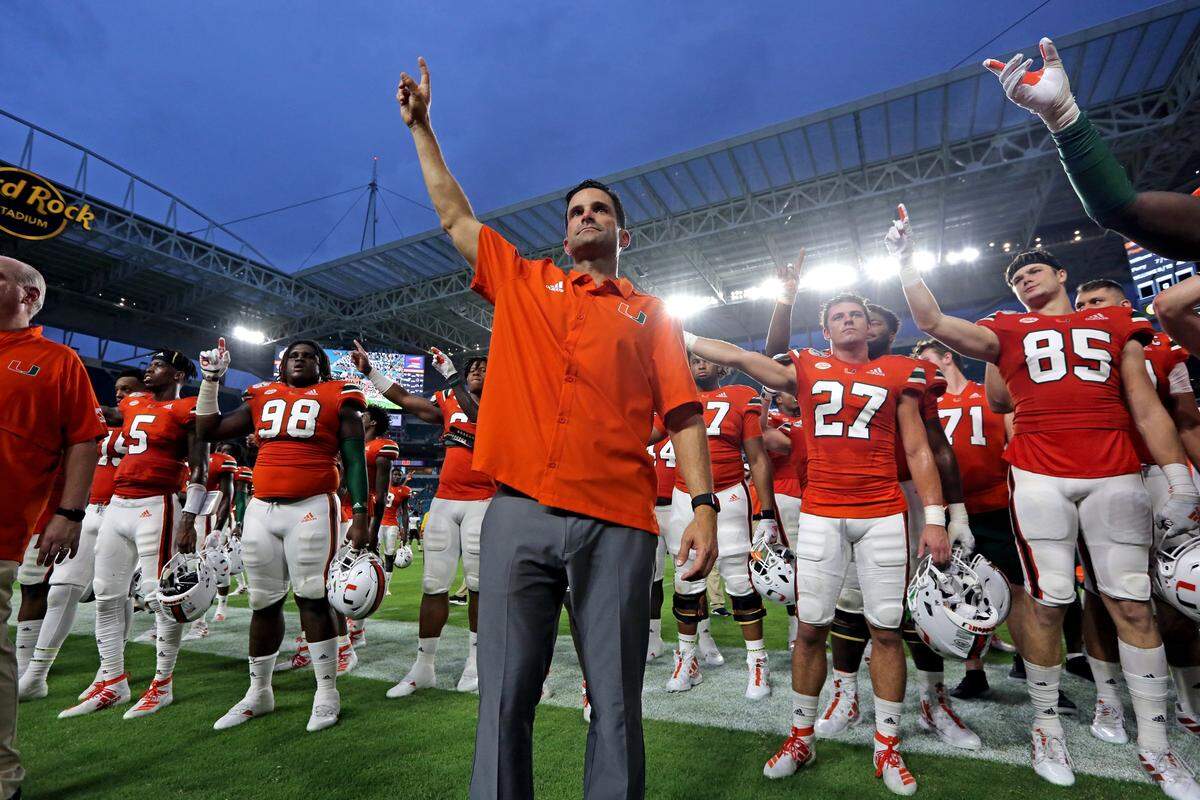 Miami Hurricanes head coach Manny Diaz and the football team hold up their hands up during the school Alma Mater as the University of Miami Hurricanes defeats Bethune-Cookman Wildcats 63-0 at Hard Rock Stadium in Miami Gardens on Saturday, Sept. 14, 2019.