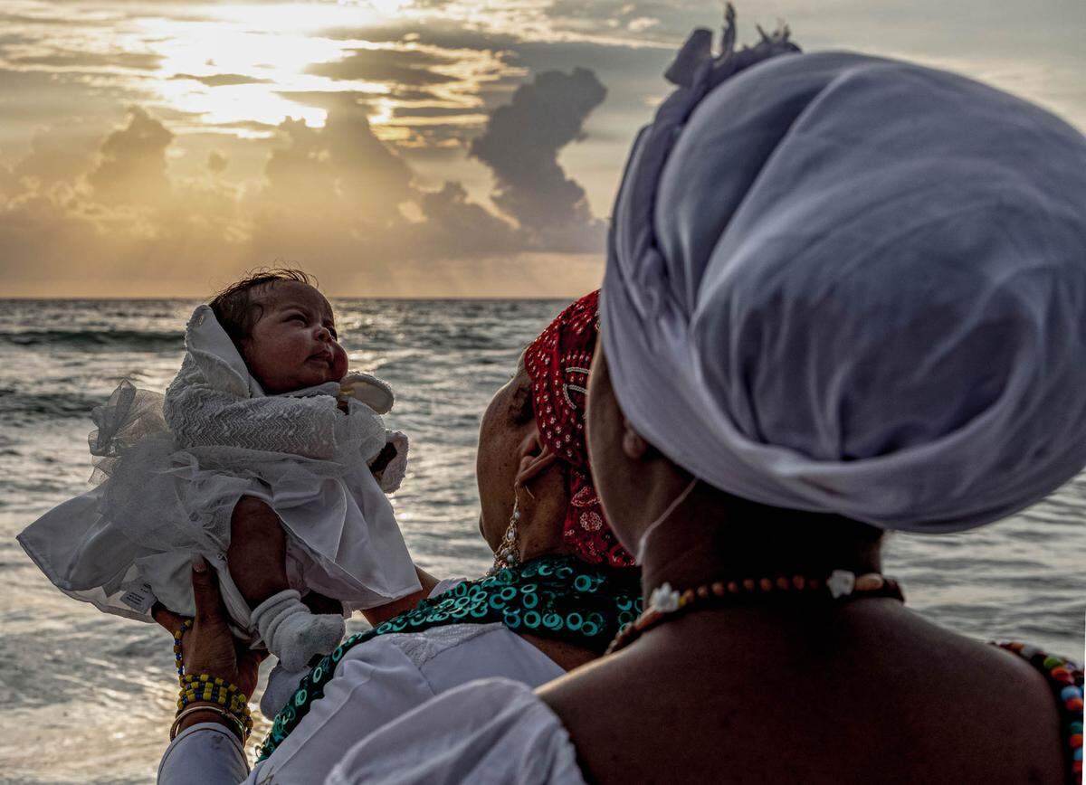 “Holy Water” A Vodou baptism ceremony at Dania Beach is captured by Little Haiti photographer, Woosler Delisfort as a part of his new show “SANCTUARY: Our Sacred Place” which showcases religious origins of Afro-Caribbeans populations in Miami.