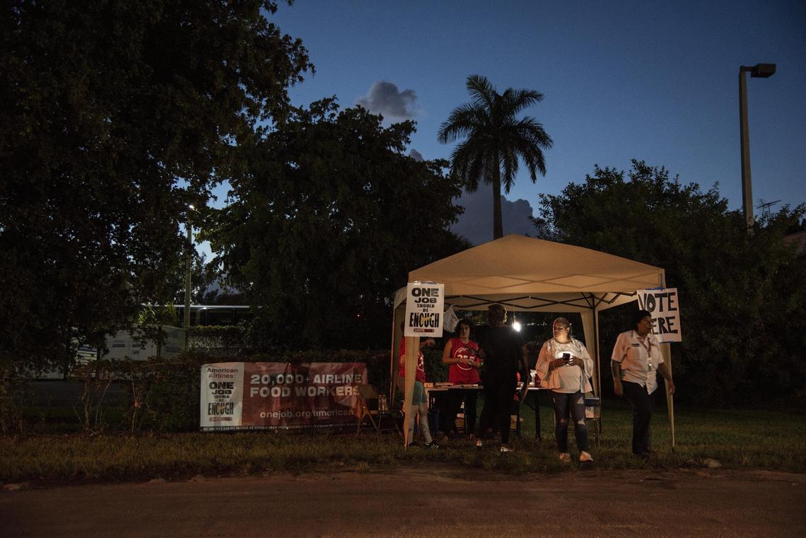 Union workers and employee volunteers wait for more LSG Sky Chefs employees to stop by their tent and vote in favor of a strike, on June 13, 2019.