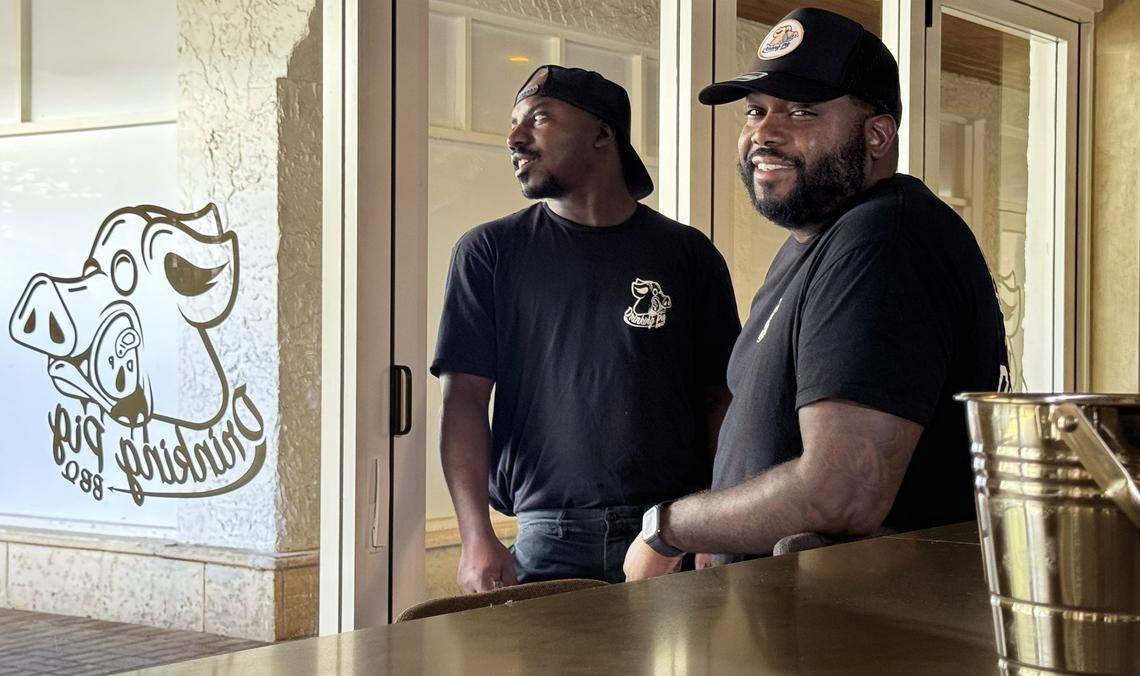 What started as a popular pop-up barbecue stop in a North Miami front yard during the pandemic has transformed into Raheem Sealey's first brick-and-mortar, Drinking Pig BBQ, in the heart of Coconut Grove. Partner Mark Wint, left, and Raheem Sealey are photographed inside the Grove's newest eatery, the Drinking Pig BBQ on Main Highway, which he plans to open in several days in Coconut Grove, Florida, on Tuesday, November 24, 2025.