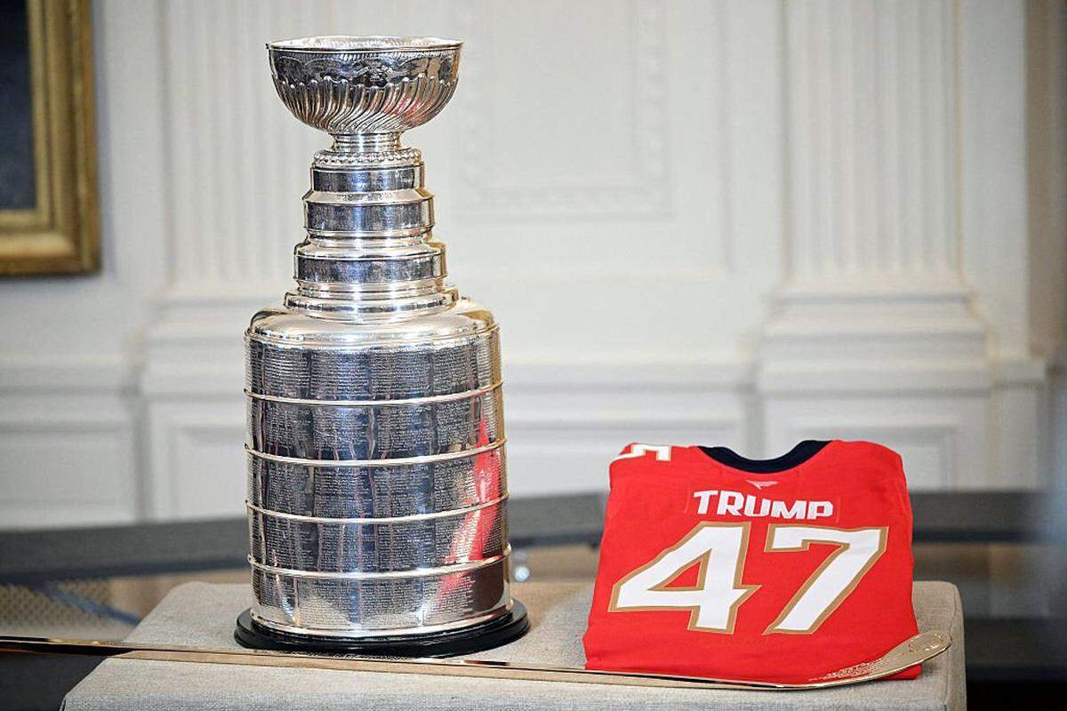 The Stanley Cup and a team shirt with the US President Donald Trump's name are displayed during a ceremony with the Florida Panthers of the National Hockey League, winners of the 2025 Stanley Cup, in the East Room of the White House in Washington, DC on January 15, 2026. (Photo by Mandel NGAN / AFP via Getty Images)