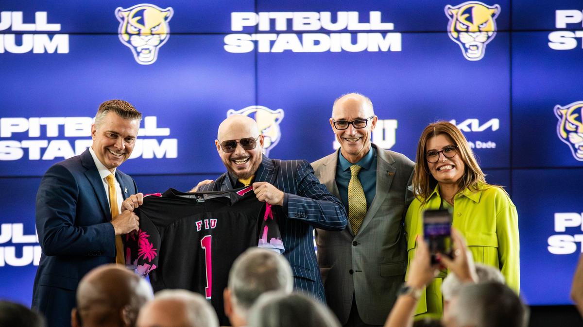 From left to right, FIU Athletic Director Scott Carr, Cuban-American artist Pitbull, FIU President Kenneth Jessell and South Dade Kia Chief Operating Officer Lucy Benedetti pose for a picture at Tamiami Hall on Tuesday, August 6, 2024 in Miami, Fla. after Pitbull announced an athletic partnership with Florida International University.