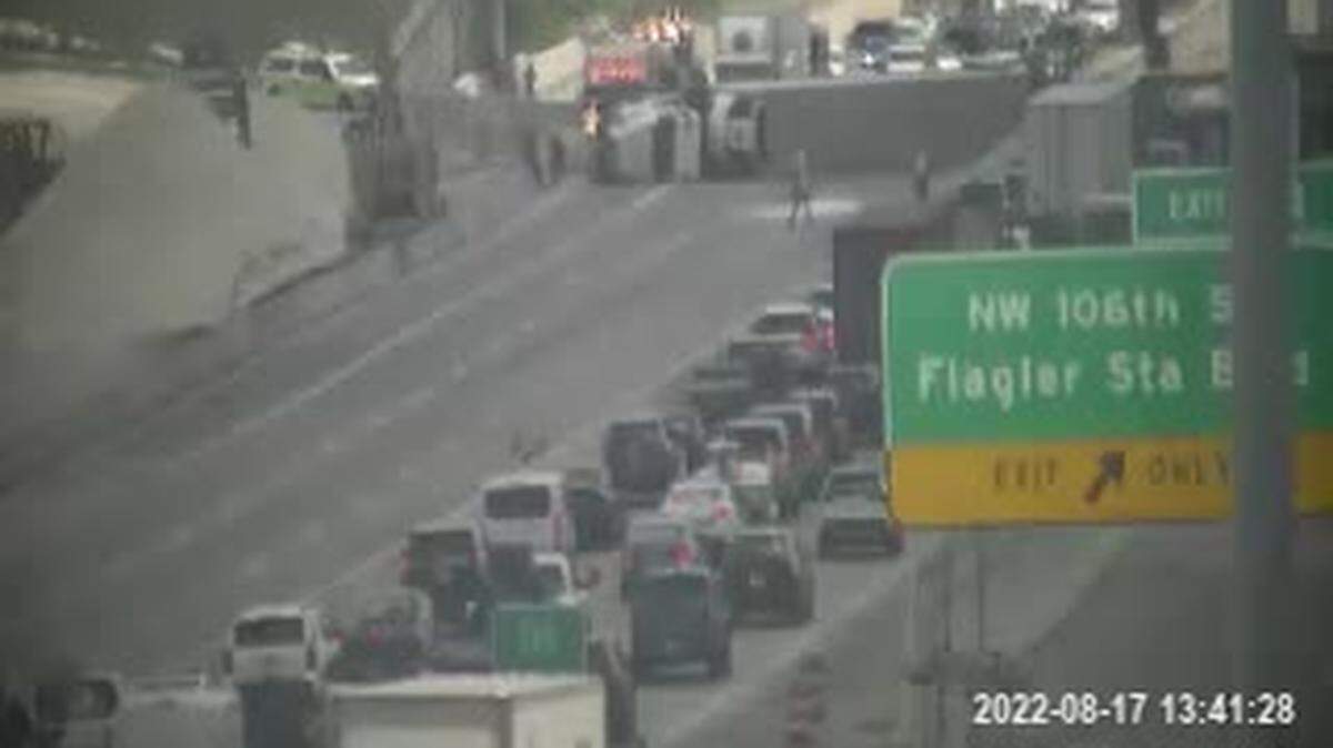 The tractor-trailer can be seen overturned on the right side of the photo from the traffic cameras.