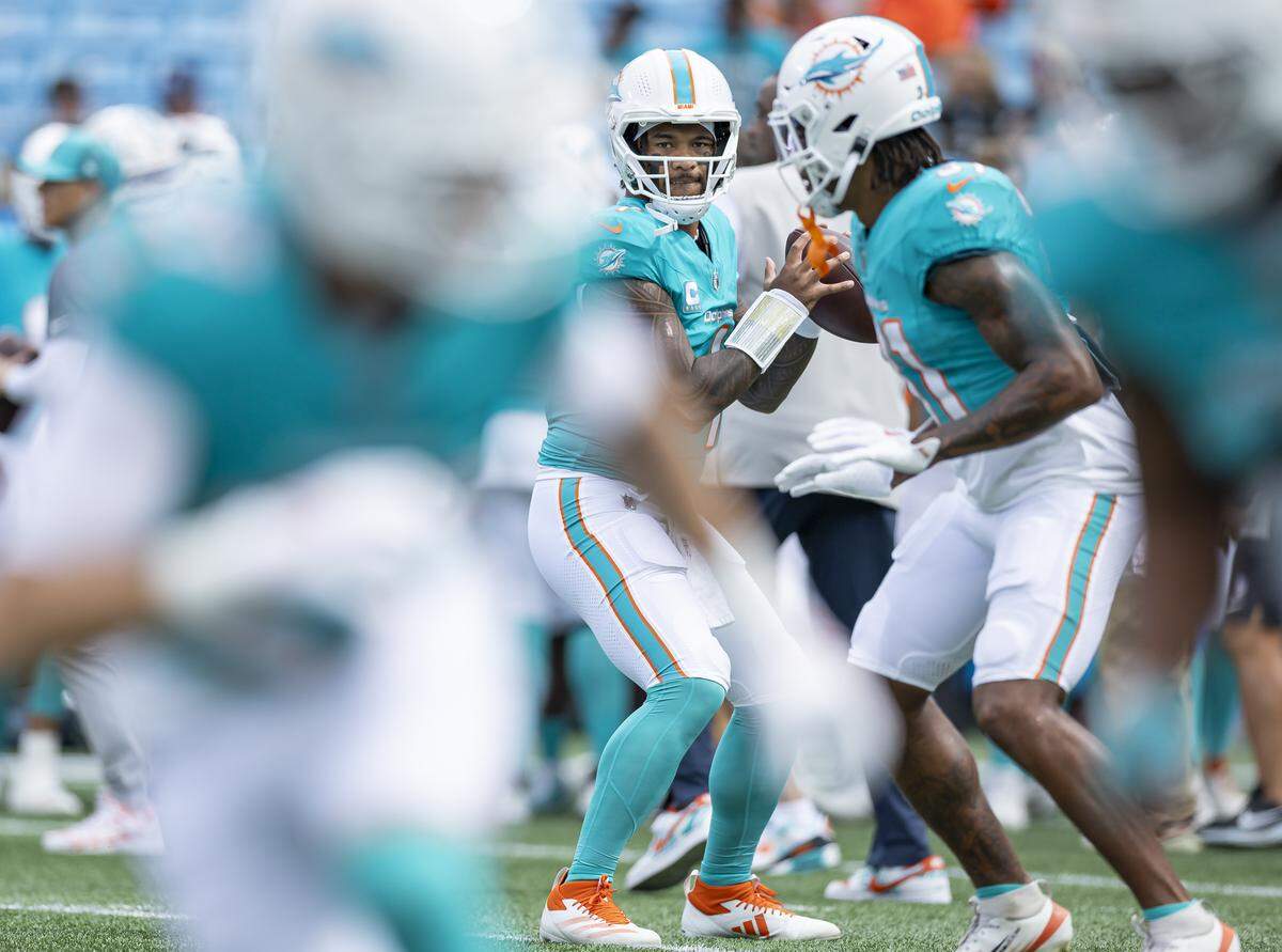 Miami Dolphins quarterback Tua Tagovailoa (1) runs drills before playing against the Carolina Panthers in their NFL game at the Bank of America Stadium on Sunday, Oct. 5, 2025, in Charlotte, N.C.