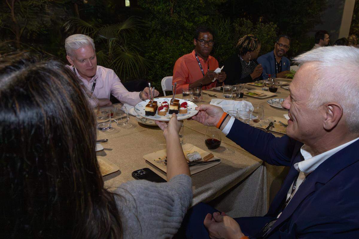 Diners share dessert at the first invitation-only Longest Table event. The Friday event is open to the public.