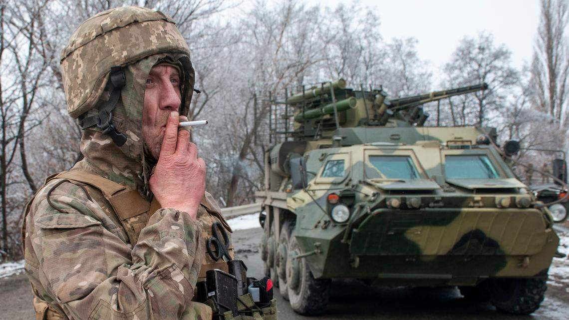 A Ukrainian soldier smokes a cigarette on his position at an armored vehicle outside Kharkiv, Ukraine, Saturday, Feb. 26, 2022. President Volodymyr Zelenskyy claimed Saturday that Ukraine’s forces had repulsed the assault and vowed to keep fighting. “We will win,” Zelenskyy said. (AP Photo/Andrew Marienko )