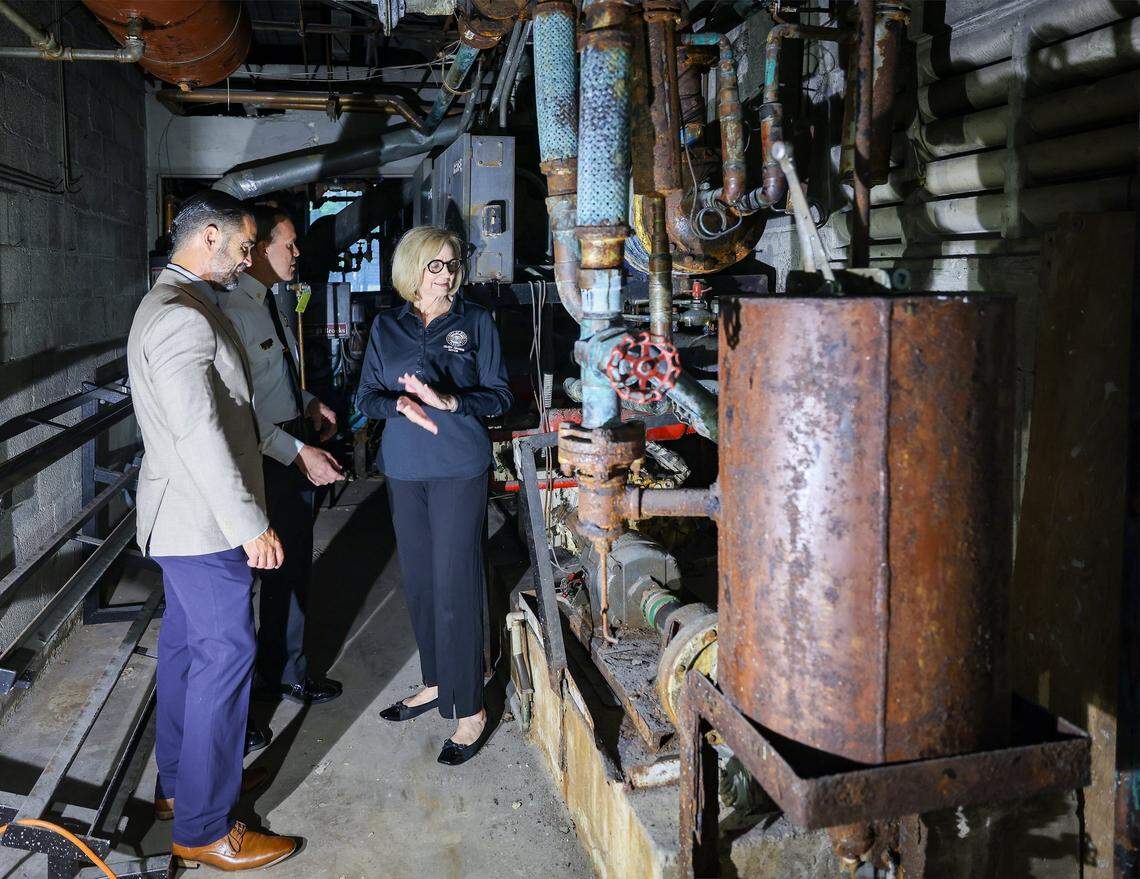 Miami Fire Chief Robert Hevia, center, tours the rusted, outdated boiler room at Fire Station 1, built in 1964, with City Manager James Reyes, left, and Mayor Eileen Higgins, right, during a press tour in Miami. Mold, water intrusion and obsolete equipment at the station are hampering emergency response and community safety. Miami Mayor Eileen Higgins toured the city's police and fire facilities in Miami, Florida on Monday, April 20, 2026. Higgins is proposing a general obligation bond to fund critical repairs and upgrades to aging public safety buildings, citing concerns over deteriorating conditions that threaten effective emergency response and community safety.