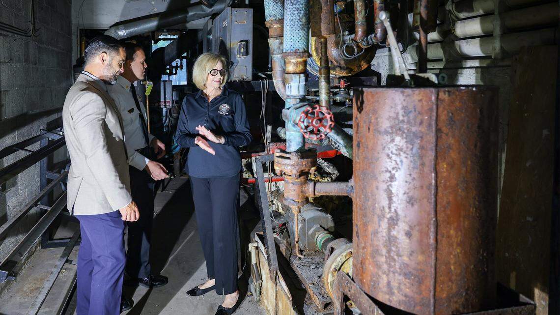 Miami Fire Chief Robert Hevia, center, tours the rusted, outdated boiler room at Fire Station 1, built in 1964, with City Manager James Reyes, left, and Mayor Eileen Higgins, right, during a press tour in Miami. Mold, water intrusion and obsolete equipment at the station are hampering emergency response and community safety. Miami Mayor Eileen Higgins toured the city's police and fire facilities in Miami, Florida on Monday, April 20, 2026. Higgins is proposing a general obligation bond to fund critical repairs and upgrades to aging public safety buildings, citing concerns over deteriorating conditions that threaten effective emergency response and community safety.