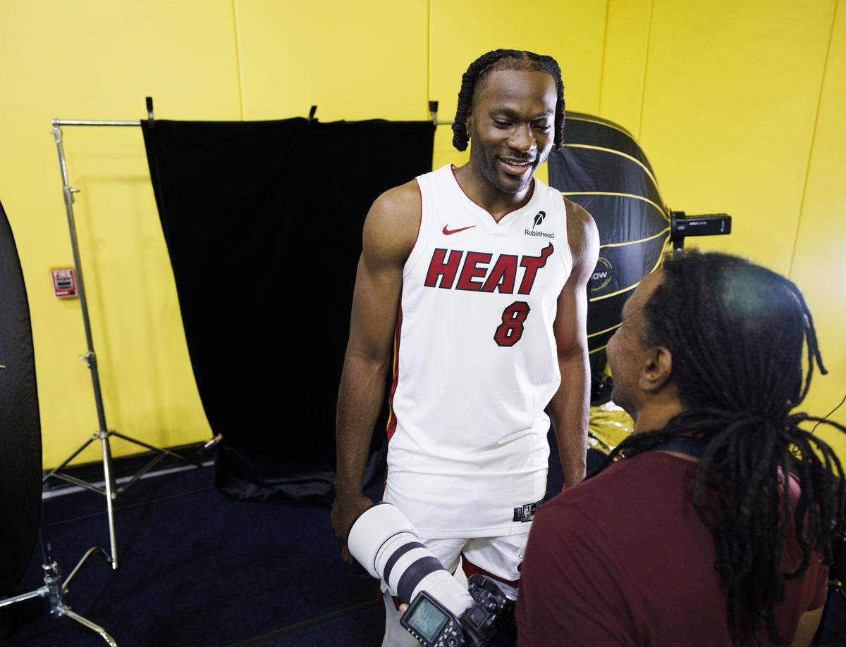 Precious Achiuwa (8) talks to Miami Herald photographer Carl Juste before his portrait during the Miami Heat Media Day on Sept. 29, 2025, at Kaseya Center in Miami.