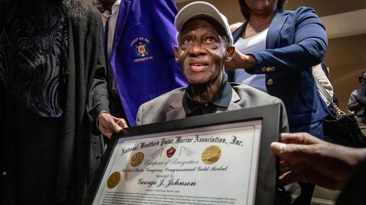 George J. Johnson, a 101-year-old Marine Corps veteran, holds a certificate he received Monday, Feb. 6, 2023, during a ceremony at the African American Research Library and Cultural Center in Fort Lauderdale. Johnson was presented an overdue Congressional Gold Medal, as well as other medals, for his service as a Montford Point Marine, the term used to describe the first Black men to serve in the Marine Corps during World War II.