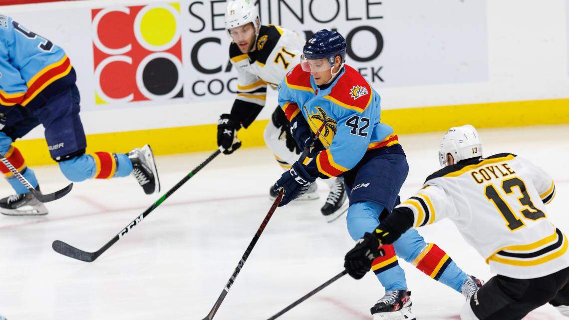 Florida Panthers defenseman Gustav Forsling (42) drives down the ice with the puck against Boston Bruins center Charlie Coyle (13) and Bruins left wing Taylor Hall (71) during the first period of an NHL game at FLA Live Arena on Wednesday, November 23, 2022 in Sunrise, Fl.