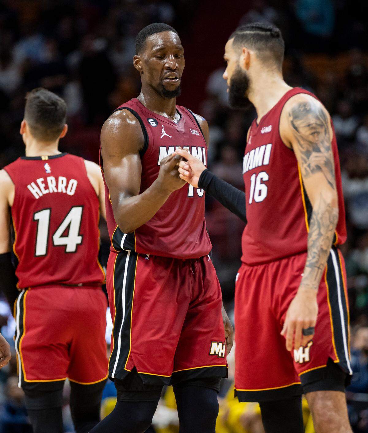 Miami Heat forward Caleb Martin (16) celebrates with center Bam Adebayo (13) after dunking against the Memphis Grizzlies during the fourth quarter of an NBA game at the Miami-Dade Arena on Wednesday, March 15, 2023, in downtown Miami, Fla.