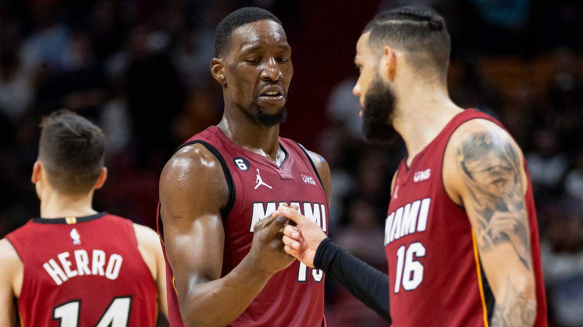 Miami Heat forward Caleb Martin (16) celebrates with center Bam Adebayo (13) after dunking against the Memphis Grizzlies during the fourth quarter of an NBA game at the Miami-Dade Arena on Wednesday, March 15, 2023, in downtown Miami, Fla.