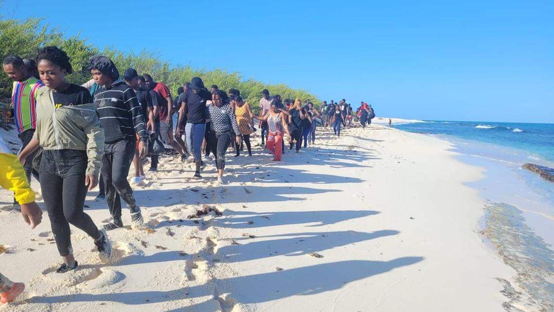 Migrants walk the beaches of Isla de Mona, where 5 people died after a suspected smuggling boat dropped them off near the uninhabited island off Puerto Rico’s western coasts.