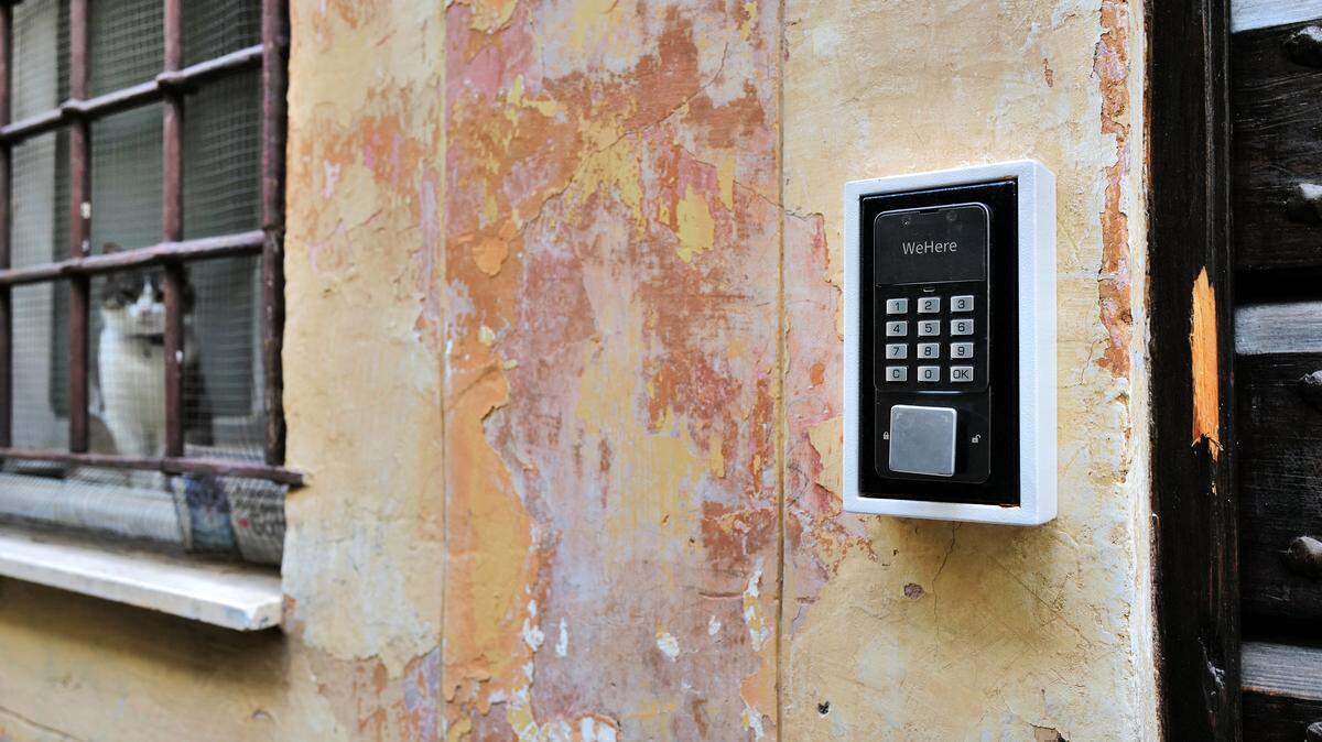 A key box protected by a numerical code is located in the street near the front door of an apartment building, for seasonal rental, airbnb, in the characteristic Trastevere district in the historic center of Rome,on November 19, 2024.