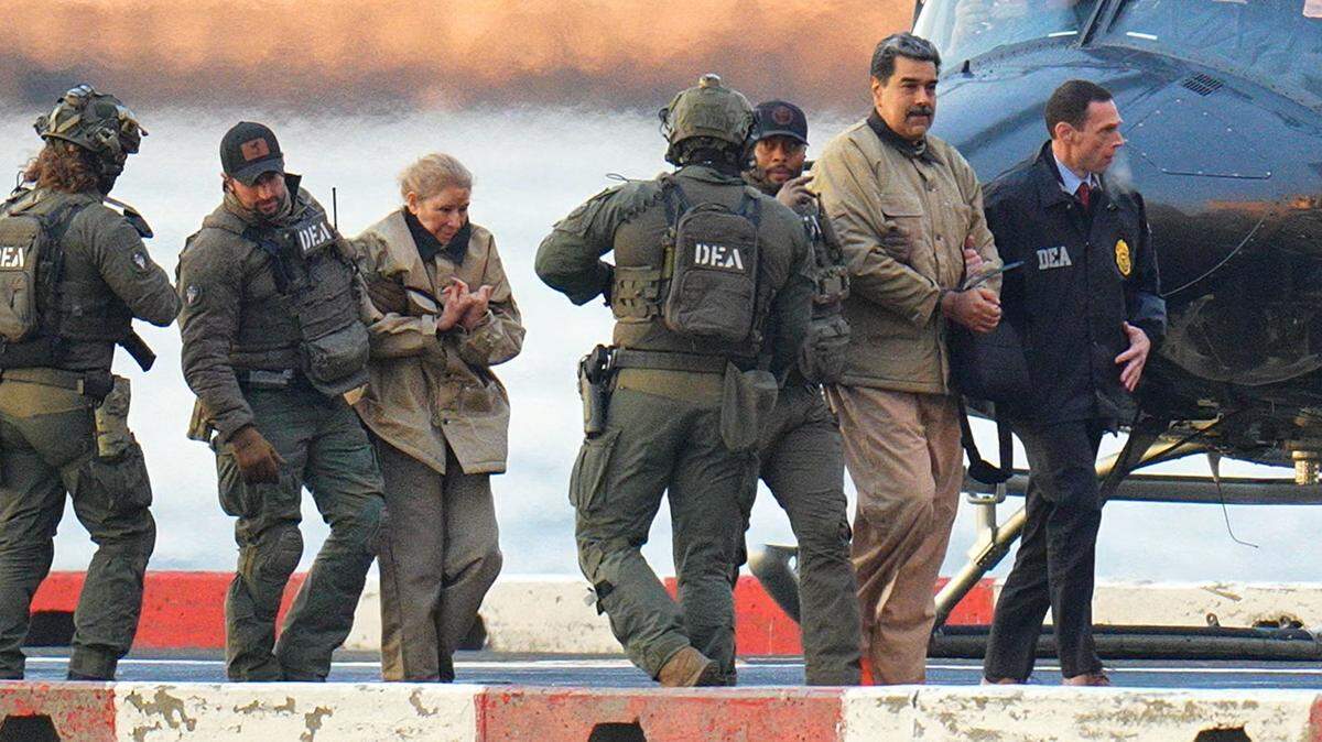 Nicolas Maduro and his wife, Cilia Flores, are seen in handcuffs after landing at a Manhattan helipad, escorted by heavily armed Federal agents as they make their way into an armored car en route to a Federal courthouse in Manhattan on January 5, 2026 in New York City.  (Photo by XNY/Star Max/GC Images)