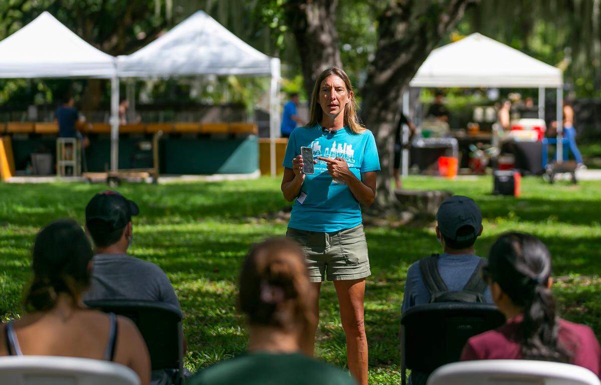 Tiffany Troxler, an associate professor in the Department of Earth and Environment at Florida International University, instructs a group of volunteers during a citizen science event at Legion Park on Saturday, Sept. 10, 2022, in Miami, Fla. The “Shading Dade” event tasked members of the public with placing heat sensors in specific locations across Miami-Dade County to help record heat temperatures.