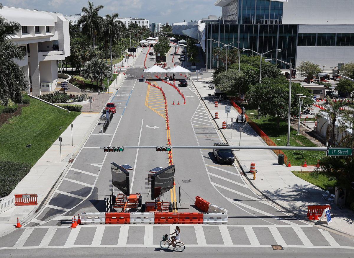Florida National Guard soldiers greet motorists as they enter the Miami Beach Convention Center for COVID-19 testing at the drive-through mobile testing service entrance on Convention Center Drive. Walk-up testing service was also made available within the municipal parking lot for individuals wishing to be tested (wearing a face covering and with photo ID) on Wednesday, May 20, 2020.