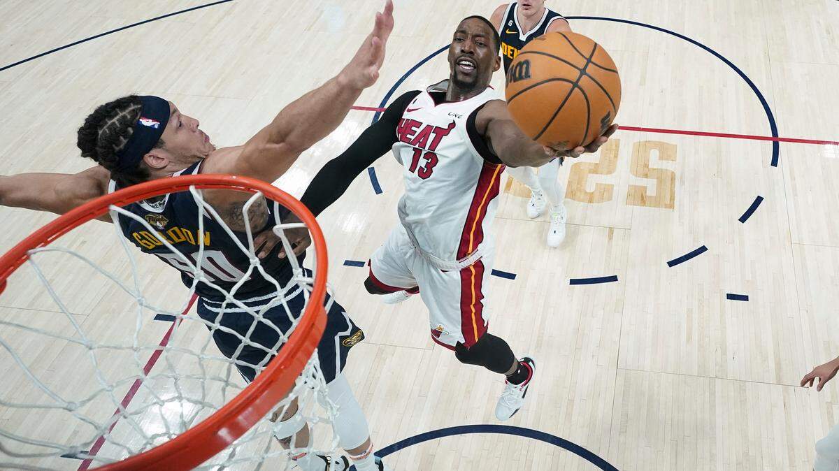 Miami Heat center Bam Adebayo (13) shoots the ball while defended by Denver Nuggets forward Aaron Gordon, left, during the second half of Game 2 of basketball’s NBA Finals, Sunday, June 4, 2023, in Denver. (AP Photo/Mark J. Terrill, Pool)