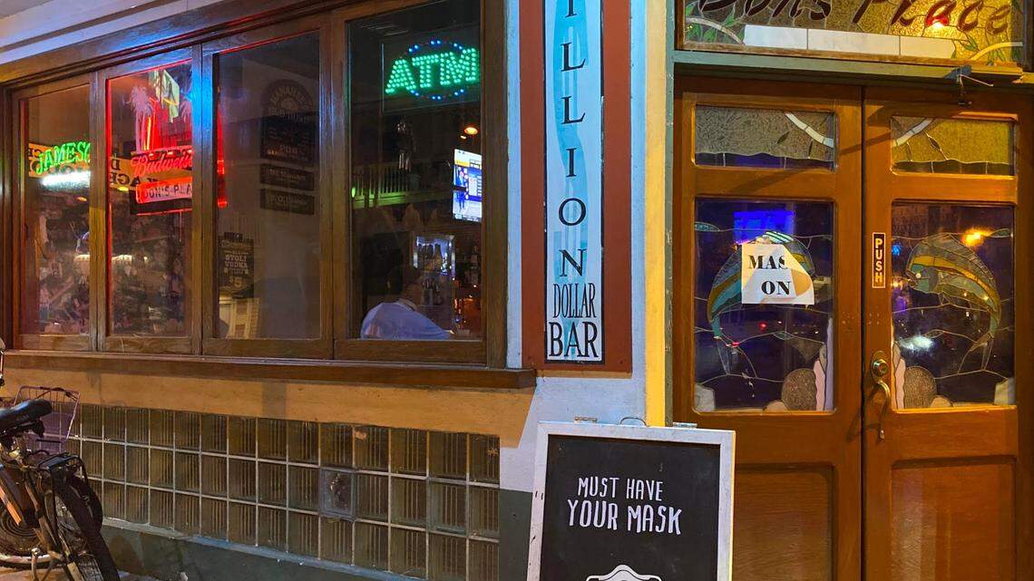 Dons’ Place in Key West reminds customers to wear their masks when entering the bar.