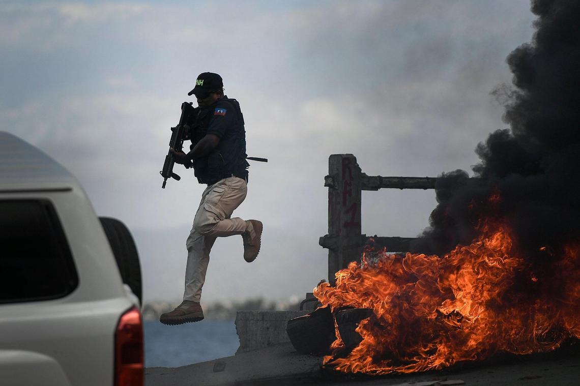 A police officer abandoned his vehicle during a demonstration that turned violent in which protesters demanded justice for the assassinated President Jovenel Moïse in Cap-Haitien, Haiti, Thursday, July 22, 2021.