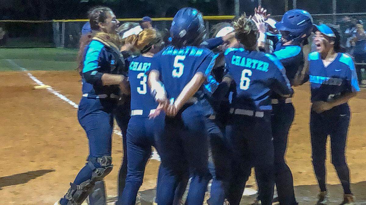 The Coral Springs Charter softball team celebrates at home plate after Cassidy Crump hit a three-run home run in the fifth inning of the BCAA Big 8 softball championship game on Thursday, April 18, 2019.