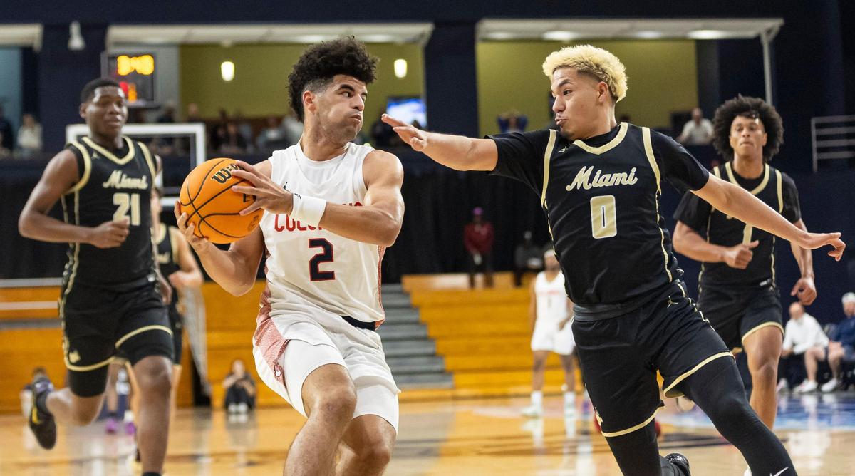 Columbus Explorers Cayden Boozer (2) drives the ball as Miami Stingarees Joseph Murillo (0) defends in the first half of their Region 4-7A championship basketball game final at the Ocean Bank Convocation Center on Thursday, Feb. 20, 2025, in Miami, Fla.