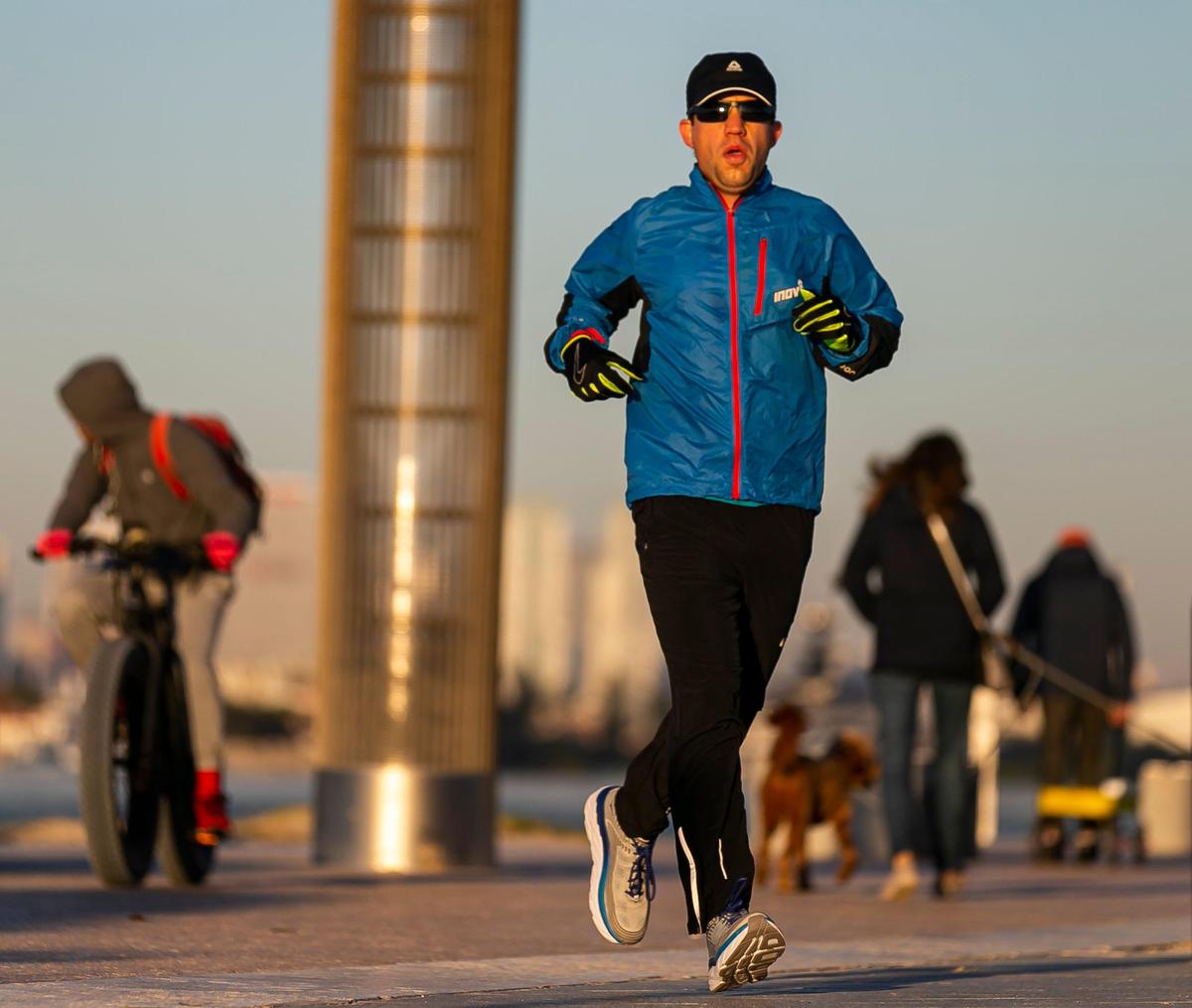 Runners make their way to South Pointe Park Pier in Miami Beach as temperatures dip into the low 40s and upper 30s on Wednesday, January 22, 2020.
