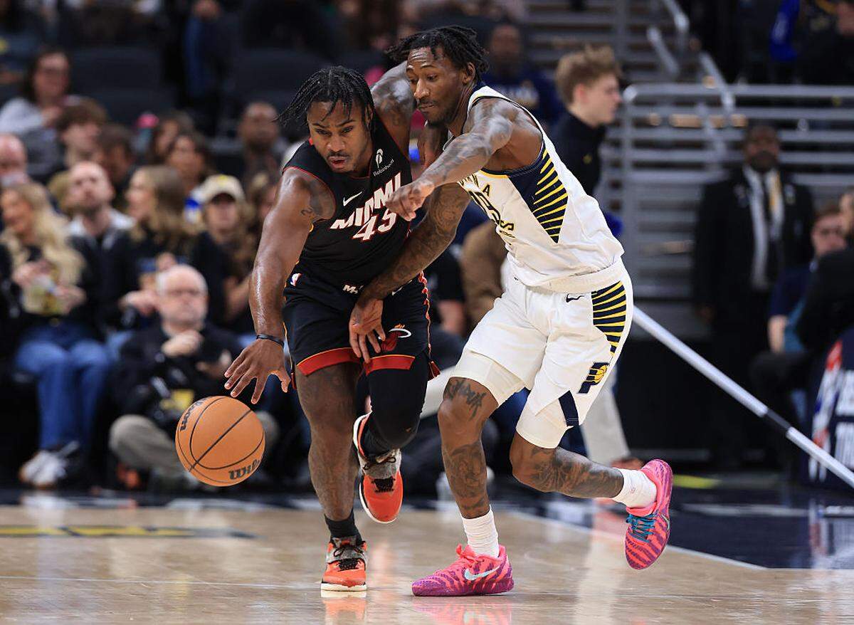 Davion Mitchell #45 of the Miami Heat brings the ball up the court against Quenton Jackson #29 of the Indiana Pacers during the first half at Gainbridge Fieldhouse on January 10, 2026 in Indianapolis.