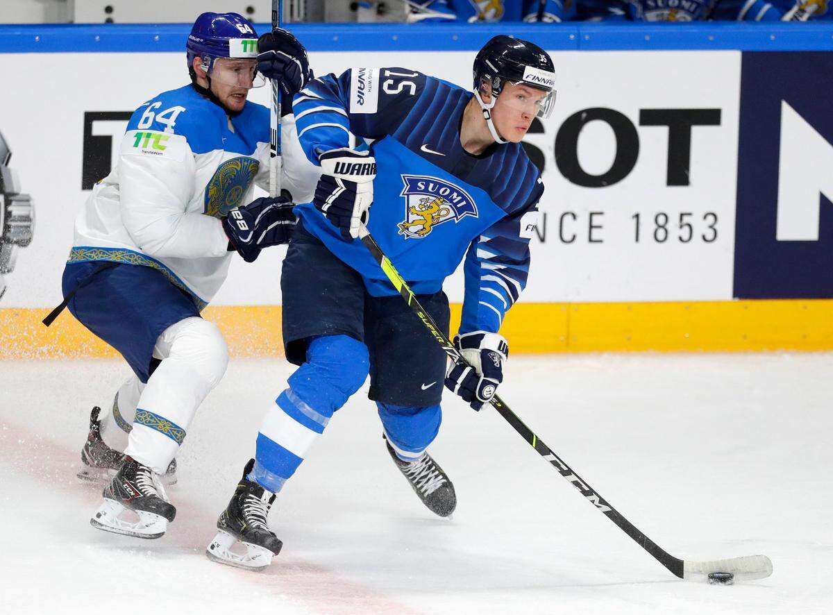 Kazakhstan’s Arkadi Shestakov, left, challenges for the puck with Finland’s Anton Lundell during the Ice Hockey World Championship group B match between Kazakhstan and Finland at the Arena in Riga, Latvia, Sunday, May 23, 2021. (AP Photo/Sergei Grits)